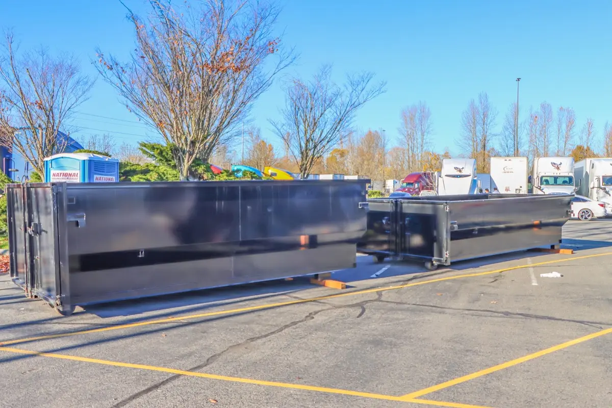 Professional dumpster rental service with roll-off container on residential driveway in Waldoboro